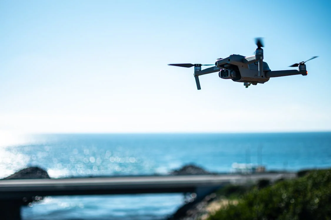 Drone Flying under Blue Sky - Photo by Justin Tonnesen